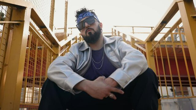 Cool hip hop stylish man showing street gesture to camera