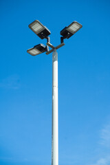 street led lamp post or lantern on a blue sky background.