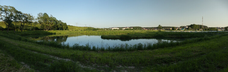 Landscape, view of the lake and the shore, green trees and water surface