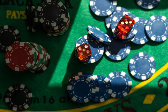 Playing cards, dice and poker chips from above on the green poker table