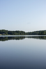 Landscape, view of the lake and the shore, green trees and water surface