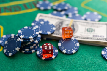 Poker chips and dollar Money bills on green cloth