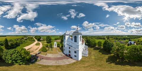 full hdri 360 panorama aerial view on red brick neo gothic catholic church in countryside or...