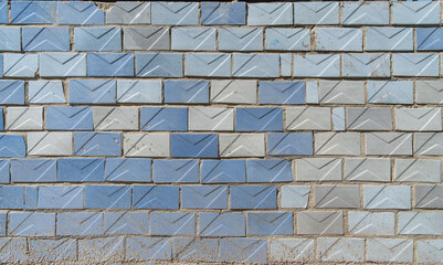 Old shabby textured wall is lined offset with old Soviet light blue and turquoise glossy ceramic...