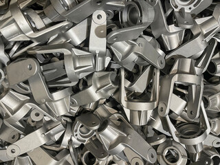 many aluminum forks, lot of die cast aluminum parts placed on mass, automotive parts mass...