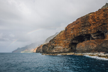 Rainbow over the mountains of the NaPali coast on the island of Kauai, Hawaii from a sunset cruise