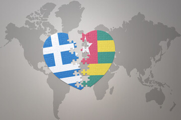 puzzle heart with the national flag of togo and greece on a world map background.Concept.