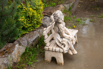 Fragment of the park with garden sculpture and plants. Landscaping.