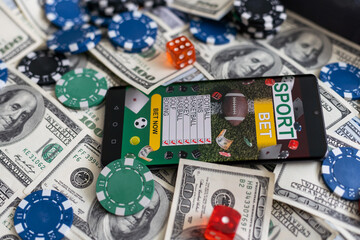 Online poker concept. Smartphone and poker chips on a green background. Poker online banner. Copy...