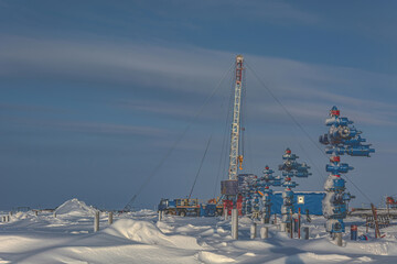 The Northern gas field. In the foreground is a row of gas producing wells. In the background, a...