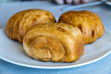Three pieces of Chinese mantou bread on a white plate