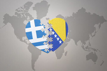 puzzle heart with the national flag of bosnia and herzegovina and greece on a world map background.Concept.