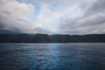 Fog over the mountains of the NaPali Coastline on the island of Kauai, Hawaii on a cloudy day from...