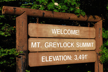 A wooden sign advises visitors they reached the summit of Mount Greylock , the highest peak in...