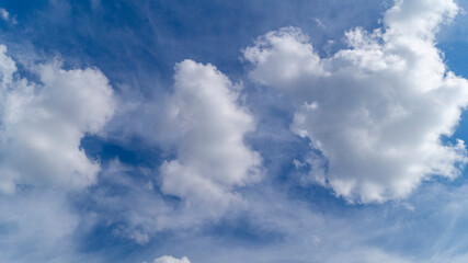 Naklejka na ściany i meble Clouds in the sky. Fluffy white clouds. The sky on a sunny day