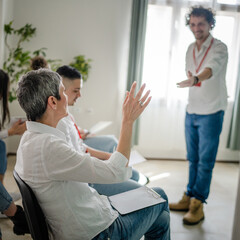 Fototapeta premium coach training speak explain question to group of employees at seminar