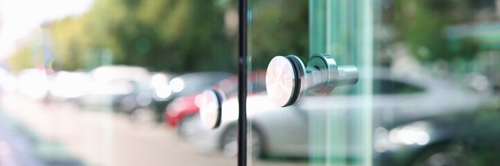 Stainless steel handle on glass door closeup