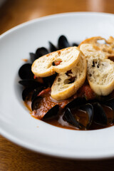 White Dish of Moules Frites Bread with Mussels