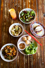 Obraz na płótnie Canvas Lunch Dinner Spread of Asian Fusion Cuisine and a Tropical Cocktail