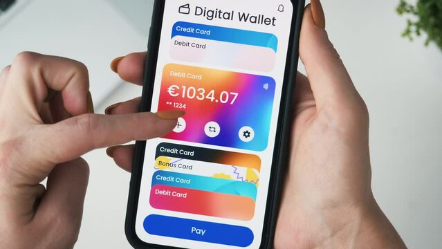 Paying with a credit card using digital wallet on the smartphone. Choosing from different credit cards for contactless payment.