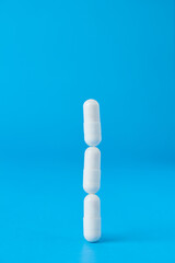 A tower of medical pills balancing