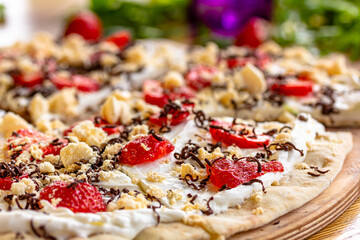 Tart with strawberries and whipped cream decorated with mint leaves