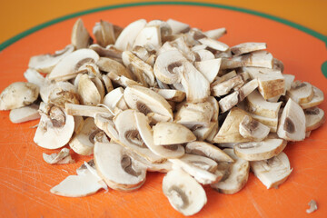  slice of champignons mushroom on chopping board 