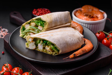 Delicious fresh roll with shrimps, tomatoes, lettuce and cucumber in pita bread