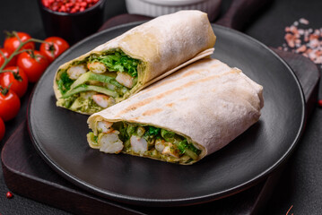 Delicious fresh roll with shrimps, tomatoes, lettuce and cucumber in pita bread