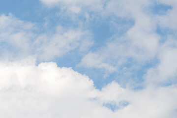 Scattered cloud clusters in a blue sky, blue sky background with white clouds.