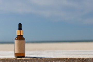 Natural calming product bottle with blank label. Beach concept. Concept with blank label. Copy...