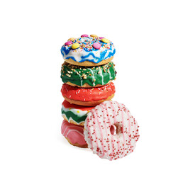 Various stacked donuts on white background