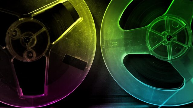 Vintage tape recorder roller. Audio reel tape is rotating at an old school professional player. Retro night club disco party or synthwave aesthetics concept. DJ remix or mixtape purple background