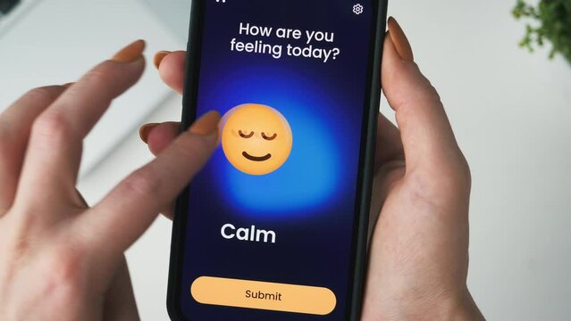 Tracking emotions on a mood tracker app. Choosing a happy emoticon and submitting it to a digital journal.