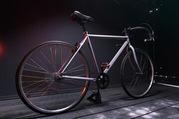 Obraz na płótnie Canvas gray street sports bike in a dark room illuminated by red light