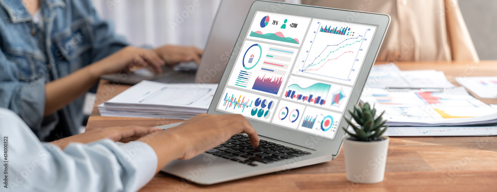Leinwandbilder Panorama shot analyst team utilizing BI Fintech to analyze financial report with laptop. Businesspeople analyzing BI power dashboard displayed on laptop screen for business insight. Scrutinize