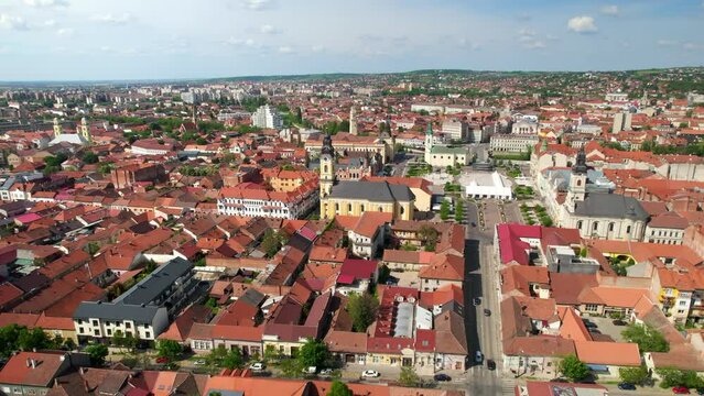 Aerial drone view of Oradea, Romania. View of the city downtown Unirii Square with multiple historical and buildings made in classic style, greenery