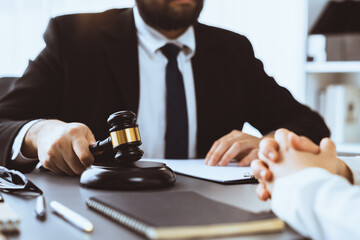 Lawyer colleagues or legal team working or drafting legal document at law firm office desk. Gavel...