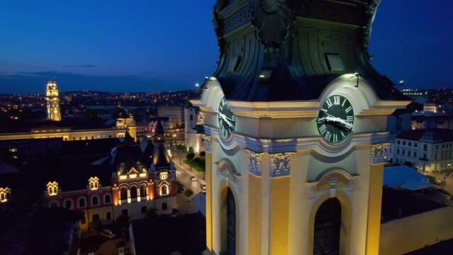Areal drone view of the Cathedral of St. Nicholas in Oradea downtown at night, Romania. Unirii Square on the background, illumination