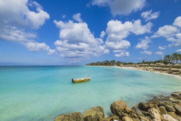 Beautiful view of Eagle Beach in Atlantic Ocean with motorboat left on water. Equipment for water sports. Aruba.