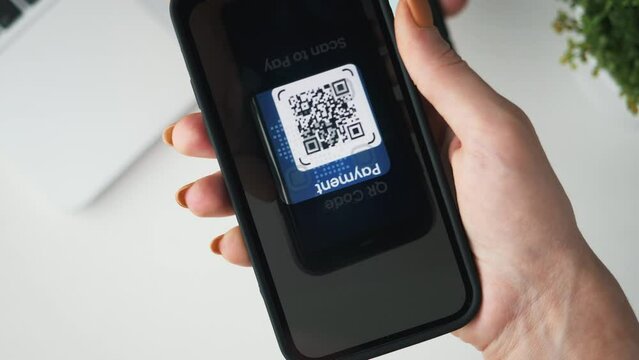 QR code payment. Using a mobile phone to scan a QR code tag and make a purchase using cashless technology.