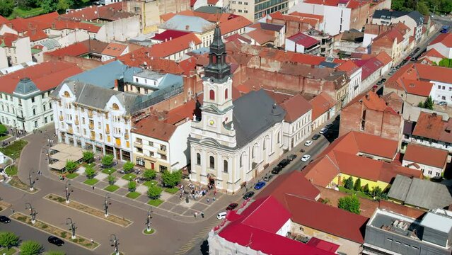 Areal drone view of the Moon Church in Oradea downtown, Romania. Historical buildings and walking people around