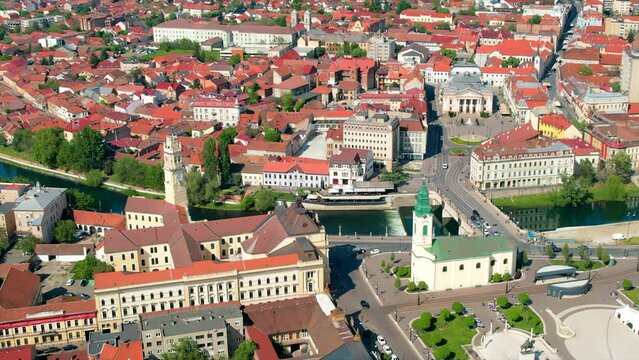 Areal drone view of the Unirii Square in Oradea downtown, Romania. Saint Ladislaus Church, Town Hall, State Theatre and other historical buildings, Crisul Repede river