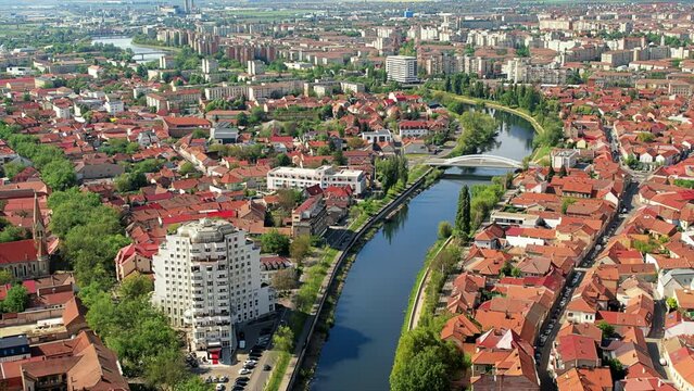 Aerial drone view of Oradea downtown, Romania. Cityscape with multiple historical buildings made in classic style, Crisul Repede river, greenery