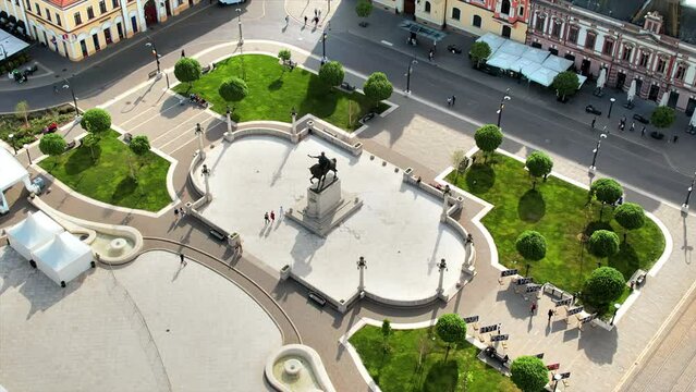 Areal drone view of the Unirii Square in Oradea downtown, Romania. King Ferdinand I statue and walking people around