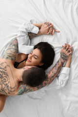 Obraz na płótnie Canvas Passionate couple having sex on bed, top view