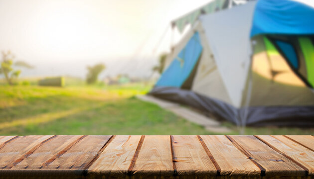 Wooden table top on blur tent camping travel tent and grass field. Fresh and Relax concept. For montage product display or design key visual layout. View of copy space.