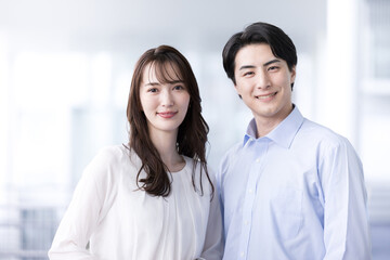 Young couple looking at the camera and smiling Image of co-workers and DINKS