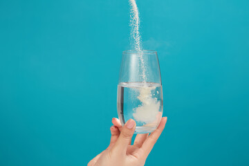 Powdered medicine being poured from above into a glass of water. Every medication has a purpose and is prescribed for a reason - Powered by Adobe