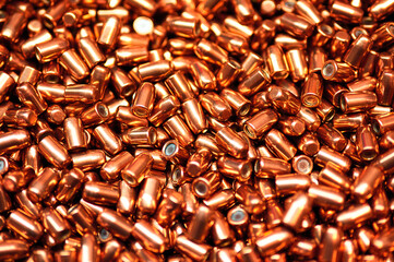 Sparkling golden bullets heap for firearms as background